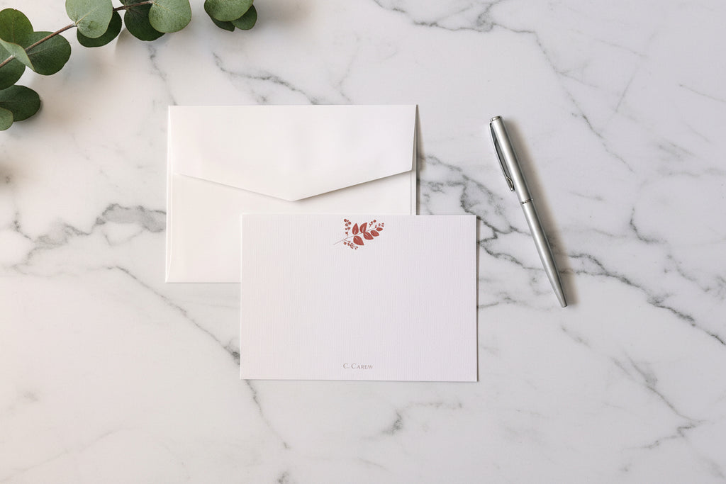 White stationery set with a pen on a light gray background
