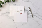 White stationery set with a pen on a light gray background